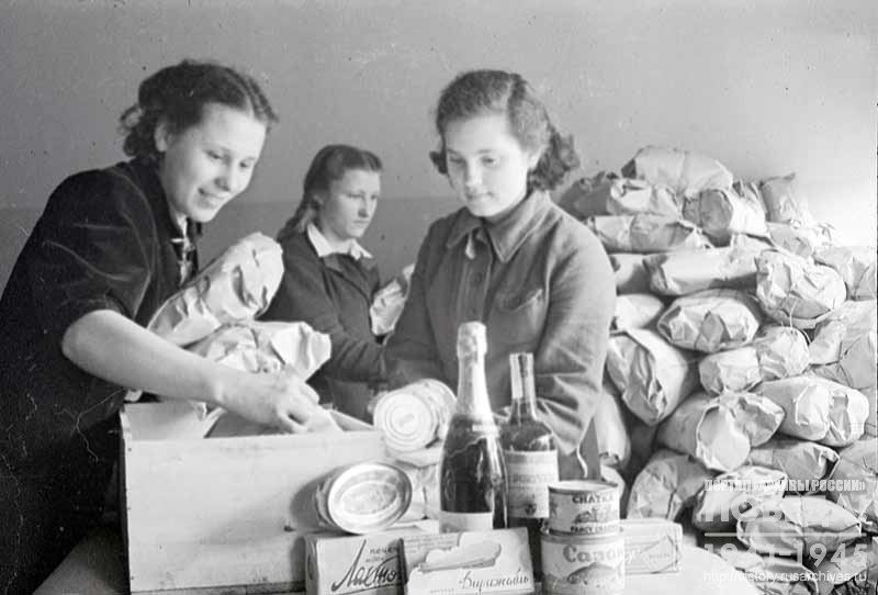 Female workers of the forwarding base assemble parcels with gifts for soldiers and commanders of the Red Army