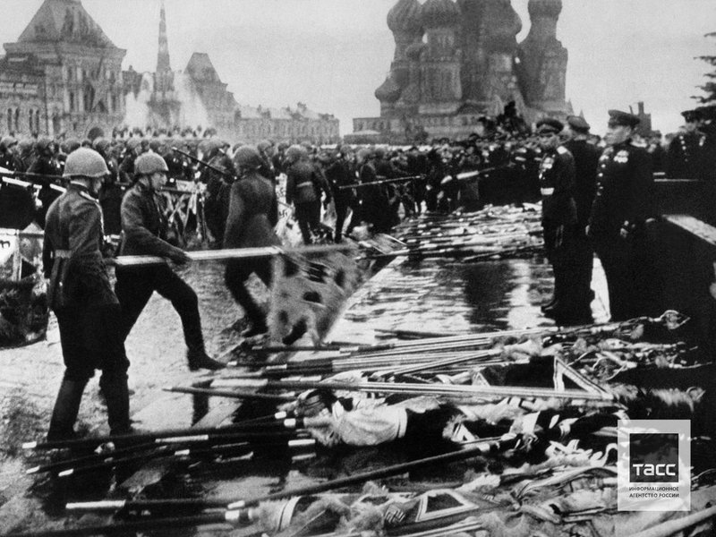 Participants of the Victory Parade with thrown to the ground banners of the defeated Nazi army after the end of the Great Patriotic War