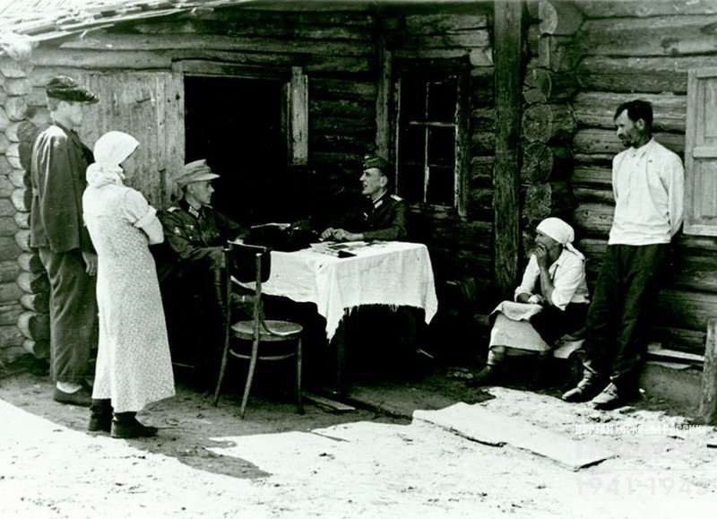 German officer interrogates residents of an occupied village