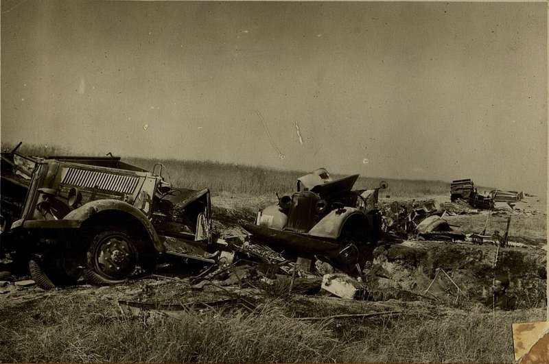 Image: 3 cars destroyed by a direct hit of 100 kg. bombs on a country road 2 km. south of Shakovo. A funnel is visible on the right side of the image.