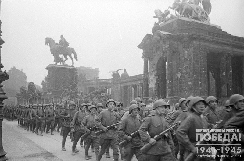 Soviet soldiers marching along a city street