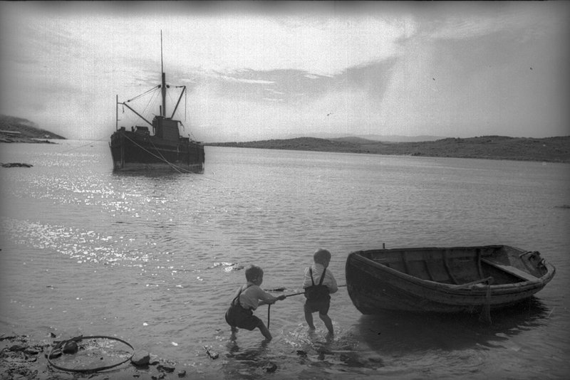 Young boys pulling a boat