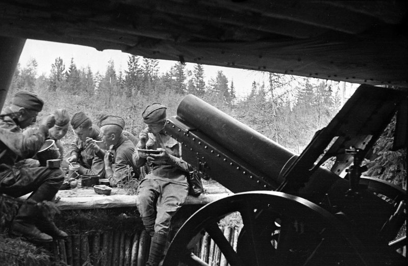 Howitzer battery soldiers at lunch near their guns on the front line of the Leningrad front