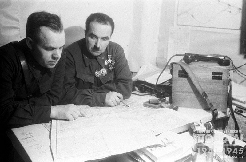 Commander of the 54th Army Major- General,  Hero of the Soviet Union Fedyuninsky I.I. and Brigadier Commissioner Kholostov D.I. in a dugout discussing an operational plan