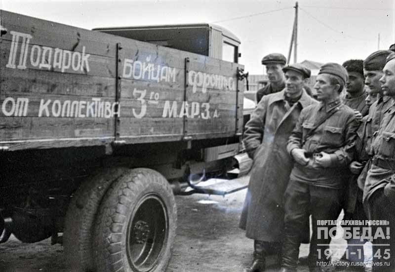 Military representative inspects trucks repaired by workers of the 3rd Moscow automobile repair plant for the sponsored military detachment