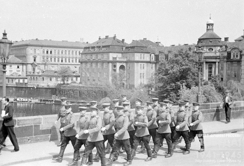 Soviet soldiers walking on the Karlov bridge in Prague