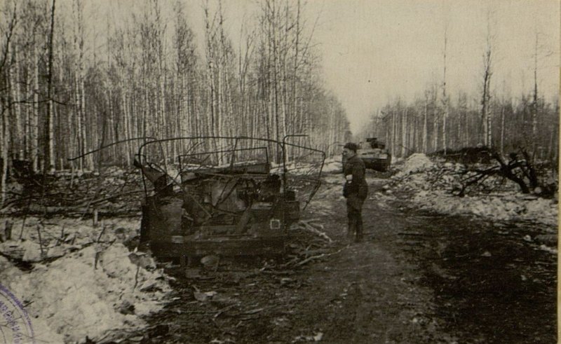 Image: Broken German tank and command vehicle at the crossroads