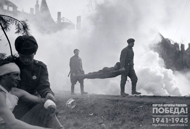 Combat medics carrying the wounded off the battlefield
