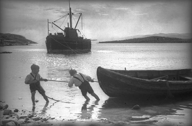 Young boys pulling a boat