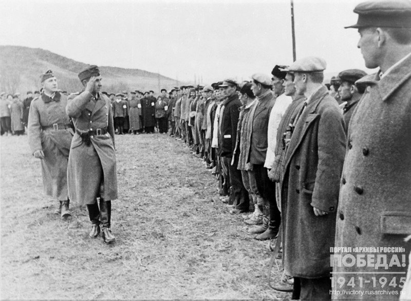 A German officer greeting a detachment of Tatar volunteers