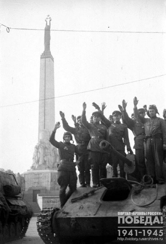 Soviet tankers saluting the residents one of the streets of Riga , Latvia