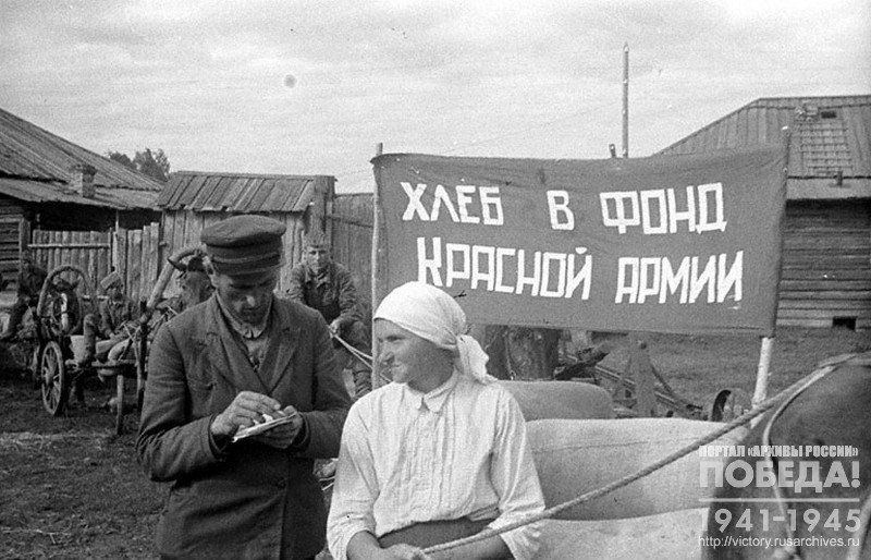 P.N. Mokeichik, Chairman of the Black Sea Village Council of the Kuzul District and the foreman of the grain wagon train from collective farm named after Stakhanov, Simanovskaya A.I., before dispatching bread to the Red Army fund