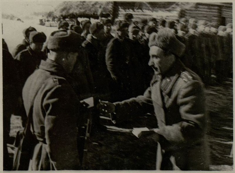 Image: The head of the political department, Lieutenant Colonel Sheboldin, presents party documents to the Red Army men and commanders of the unit, Major Aleksandrov
