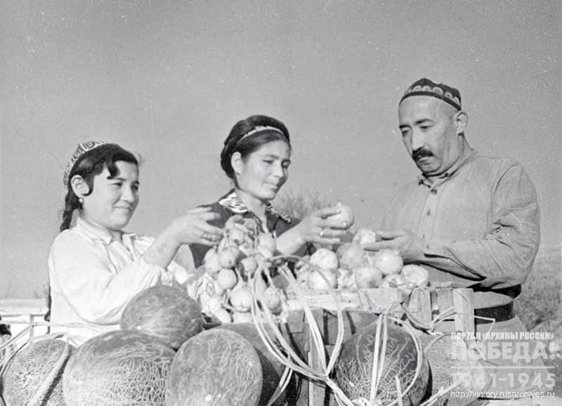 Chairman of the Stalin collective farm of Namangan Region A. Kaimov and farmers U. Soshchieva and T. Askarova pack parcels with gifts to be sent to a sponsored hospital