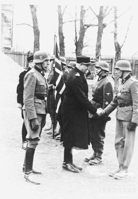 Minister of War of Norway V. Quisling welcomes soldiers during his visit of the Norwegian Legion