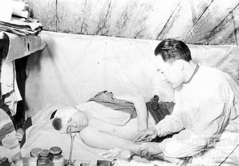 2nd class military doctor A.Ibatov, holder of "For battle merit" medal, giving medical assistance to a wounded soldier