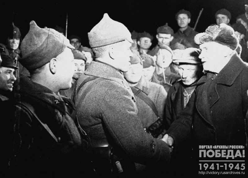 Red Army soldiers and commanders talk to inhabitants of Terijoki town