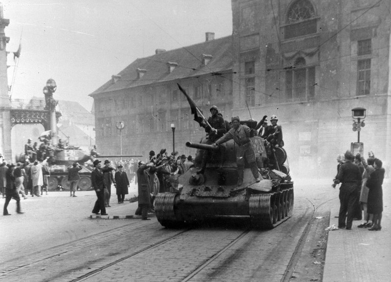Residents of Prague welcome Soviet tankers entering the city