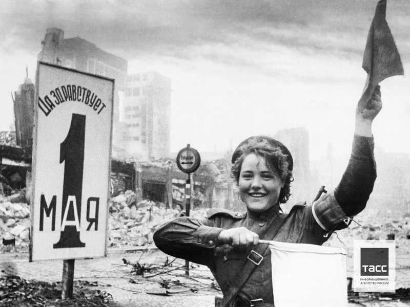 Military traffic controller Maria Shalnova on one of the streets of Berlin. Germany, May 1945