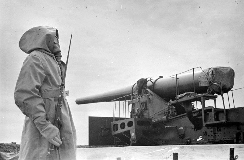 Red Navy sailor of the Baltic Fleet in a gas mask at the post at the ship's cannon