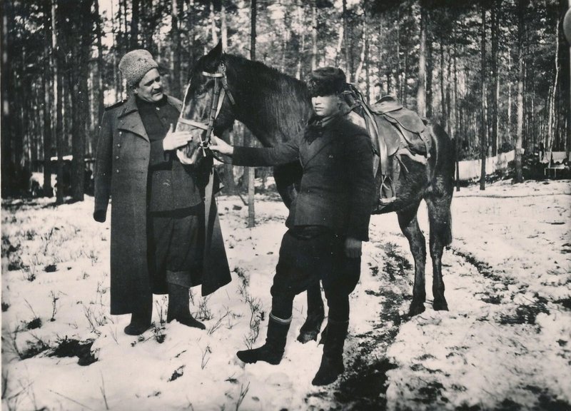 Guerrilla commander A.F. Fedorov with his orderly (standing with a horse)