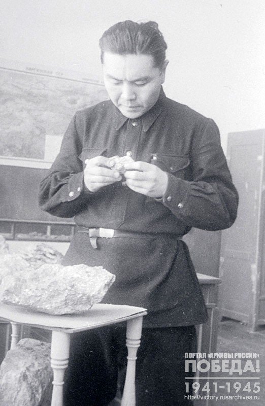 Scientific secretary of the Geological institute of the Kirghiz branch of the Academy of Sciences of the USSR A.M.Mindzhilkiev studying samples from a new tungsten ore deposit in Kirghizia