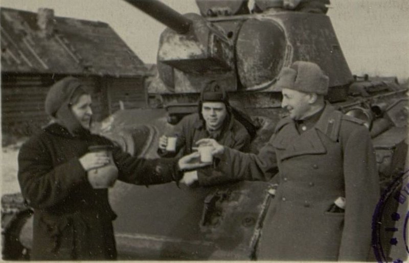Image: Citizen E. Ivanova at the meeting treats Lieutenant Colonel Kudryavtsev with milk