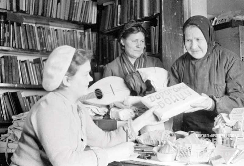 Factory workers, mothers of front line soldiers D. Ponomareva and E. Stepanovafactory pass gifts to Soviet soldiers