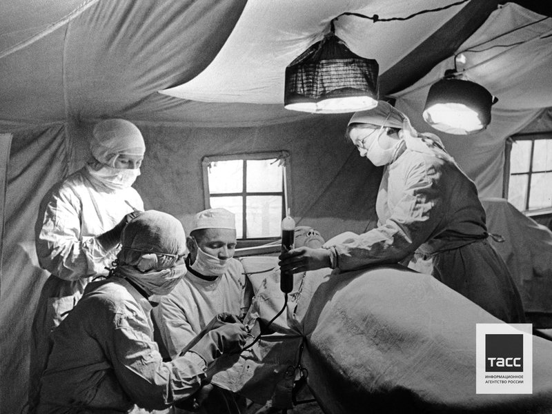 Military medics transfuse blood to a wounded Red Army soldier in field hospital