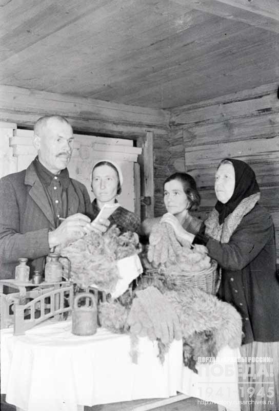 Chairman of the collective farm "Awakening" V. Ryabinin accepts from the workers of the farm self-made warm clothes to be sent to the Red Army soldiers