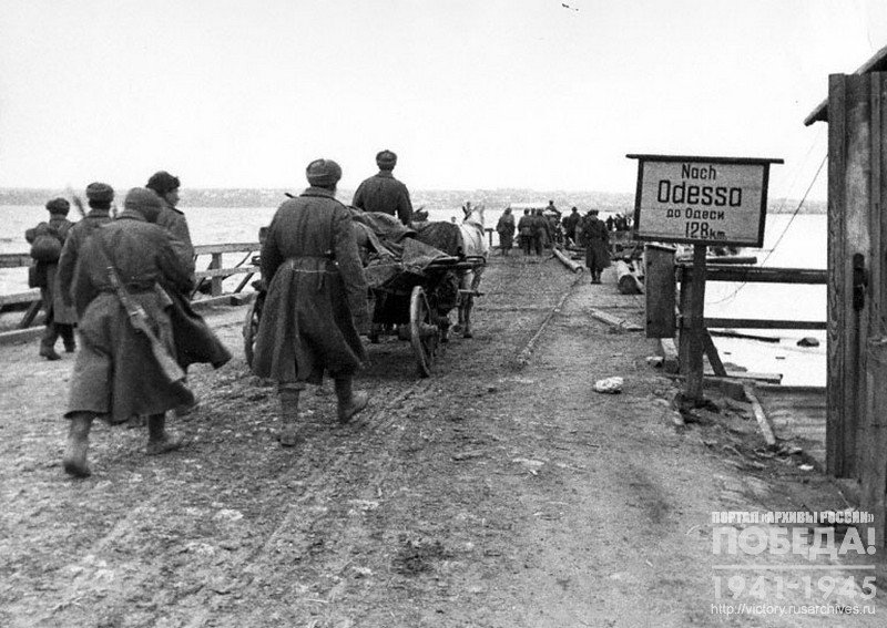 Soviet soldiers crossing the bridge over  the river