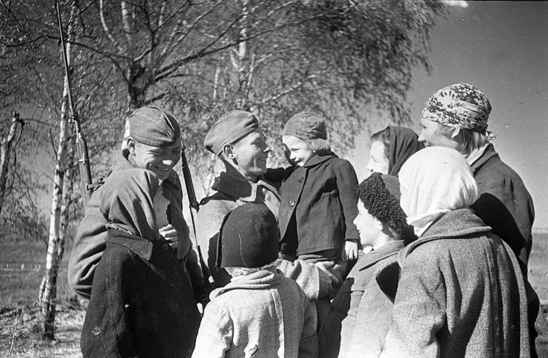 Liberated local villagers greet Soviet soldiers in the Rzhev area.