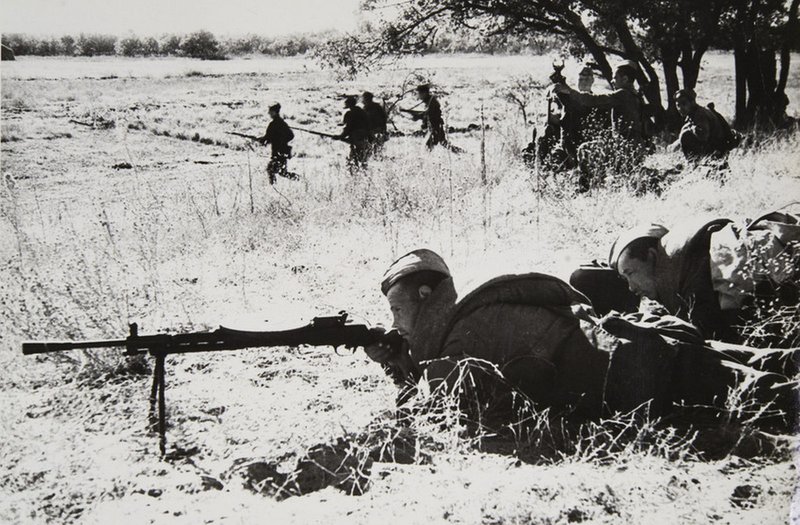 Acting army near Stalingrad. Machine gunner V. F. Rengo supports advance of his unit by fire