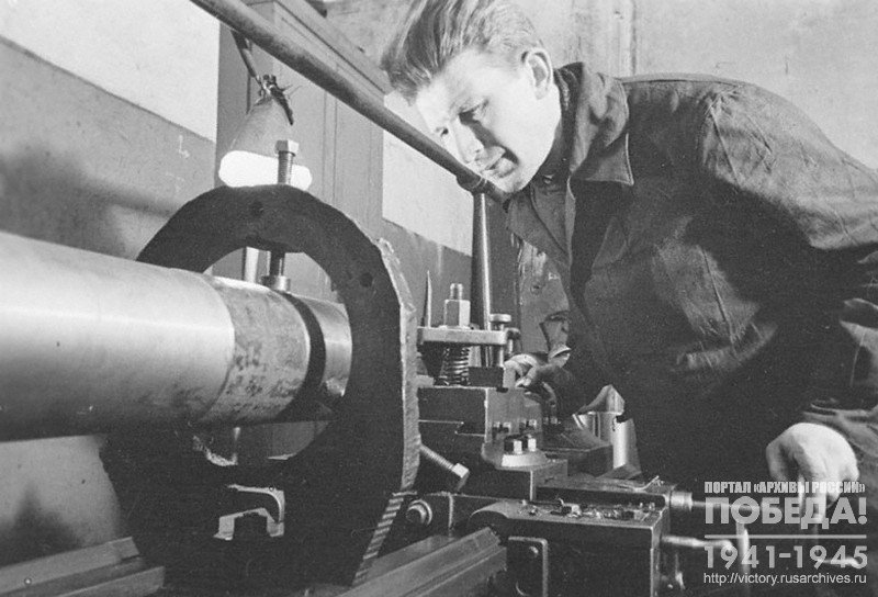 Turner-stakhanovets (winner of the socialist labour competition) of a research and development institute Kobalevskiy working on a barrel of an anti-tank weapon