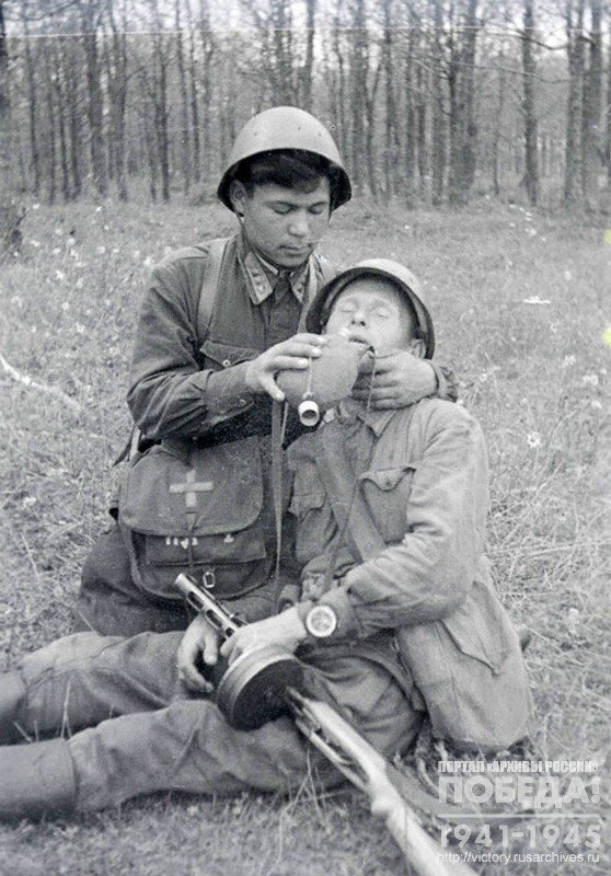 Military doctor N.Y.Yakubov giving first aid to a wounded soldier