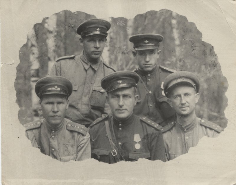 "Captain V. Rubtsov (first row, center) among a group of servicemen."