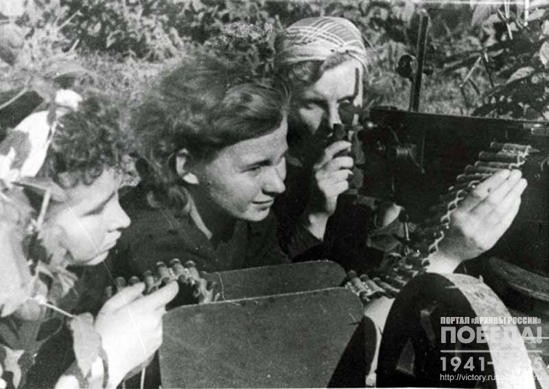 Komsomol girls at the machine gun during practical training in shooting