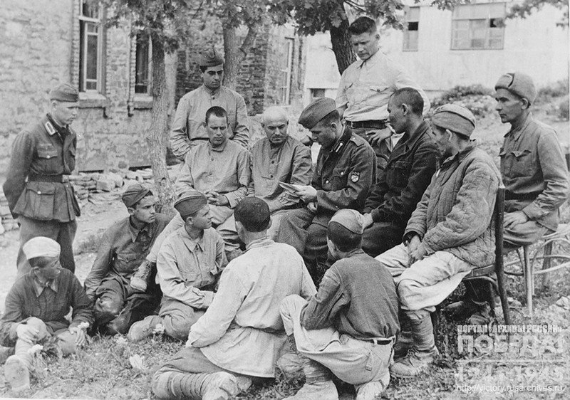 Officer of the Vlasov Russian Liberation Army is reading the appeal of Lieutenant General A. Vlasov to defectors