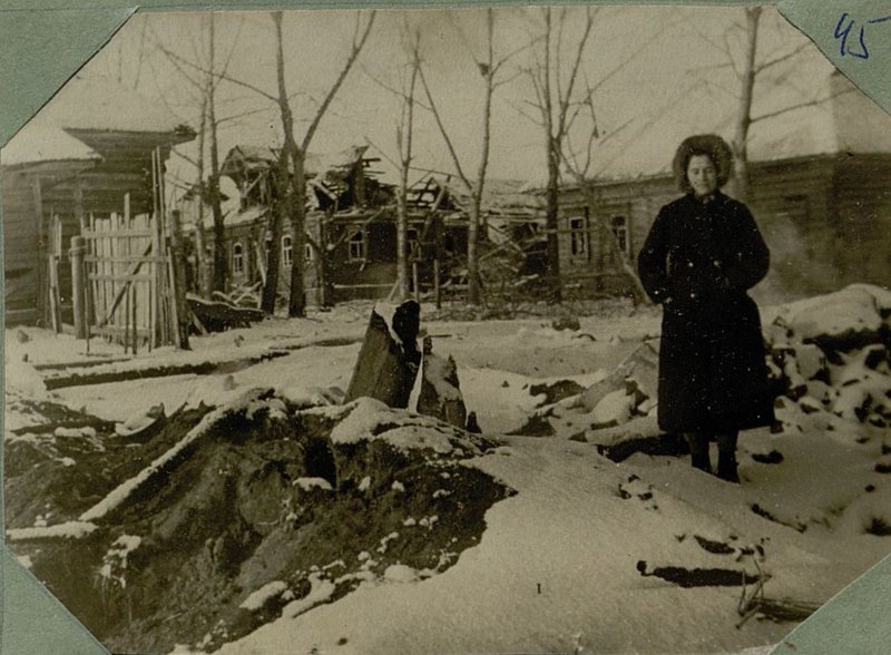 Image: Kudryasheva Ekaterina Stepanovna stands at her hut burned by the Germans, the village of Staro-Semenovskoye, Kalinin region, 10.12.41.