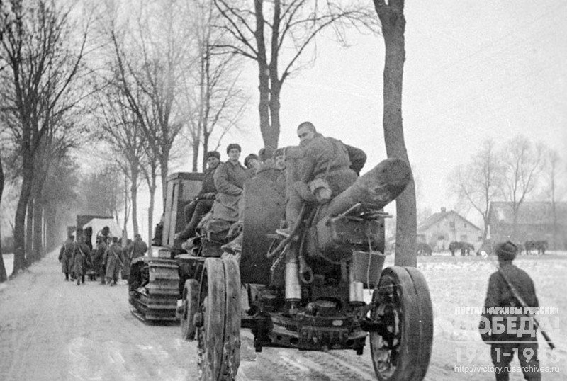Soviet heavy artillery moving on the road past one of the villages in Eastern Prussia