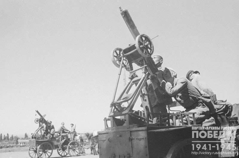 Cavalrymen learning the tactics of air defense from horse pulled carts with mounted machine guns