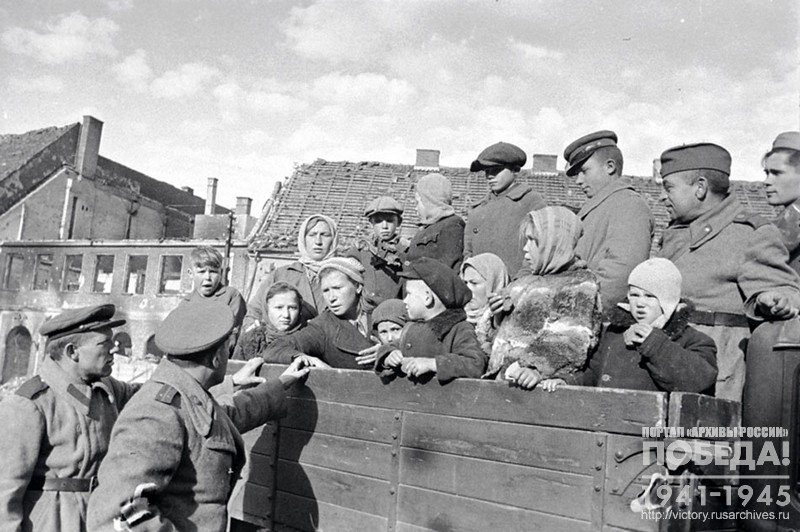 Women and children liberated by the Red Army from Staropanovo camp are talking to the Captain Chernomazov before returning home