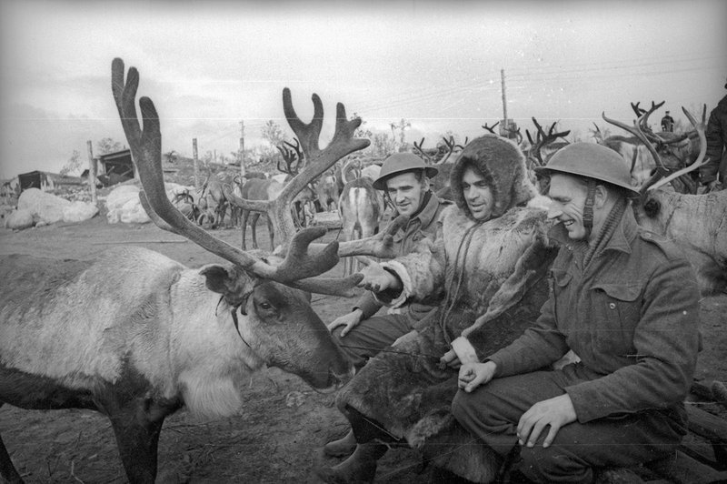 Soviet reindeer breeder with British aircraft mechanics at the airfield in the Arctic