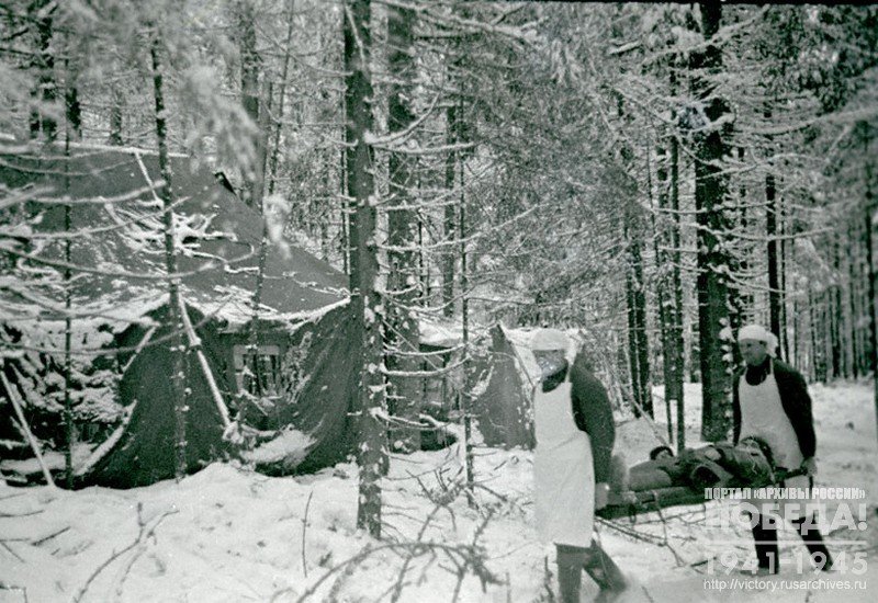 Combat medics of a field hospital of the 4th guards division carrying the wounded