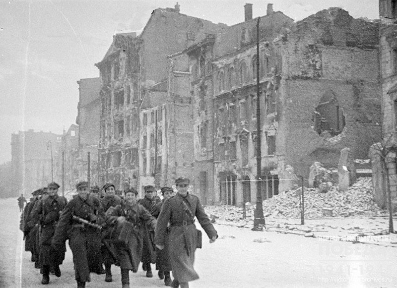 An infantry unit of the 1st Polish Army marching through one of the streets of Warsaw