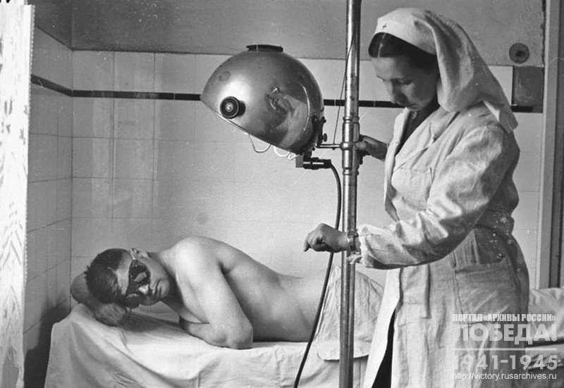 Wounded Senior Sergeant I. Gonohov undergoes a quartz treatment session. Next to him a nurse Yu. Chuvina