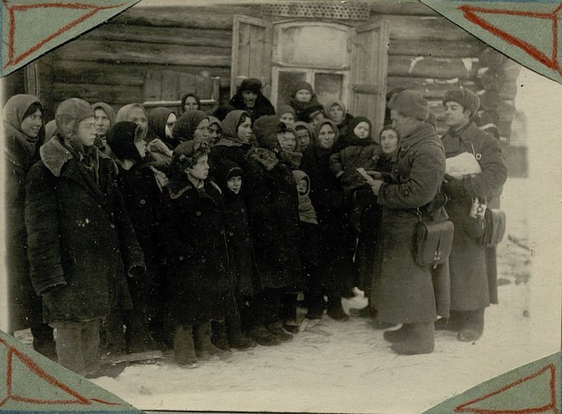 Image: Political instructor comrade Shulzhenko conducts a conversation with the population in the village of Shcherbinino, Kalinin region, liberated by the units of Comrade Berezin