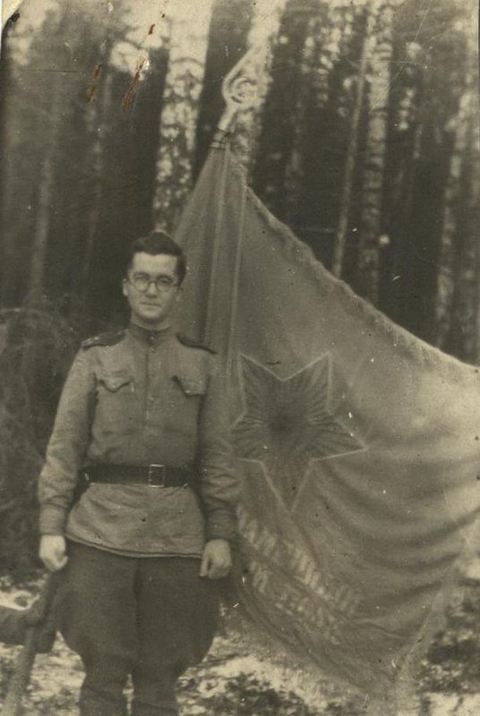 Regimental intelligence officer I.A. Beskin at the deployed regimental banner (reward from the unit commander). Field mail number 67656