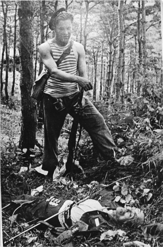 Sailor of the Pacific Fleet next to a killed Japanese officer in a forest on Sakhalin