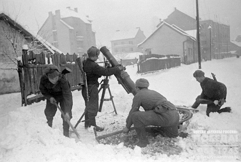 Soviet mortar crew mounting a mortar in the firing position in one of the districts of Budapest